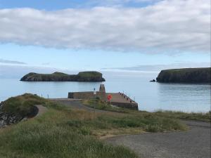 a view of a body of water with two islands at 14 Upper Bayble in Stornoway