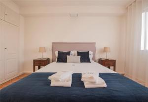 a bedroom with a large bed with towels on it at Saldanha Executive Apartment by The Portuguese Butler in Lisbon