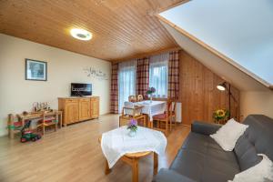 a living room with a couch and a table at Urlaub am Lacknerhof - Familie Klocker in Liebenfels