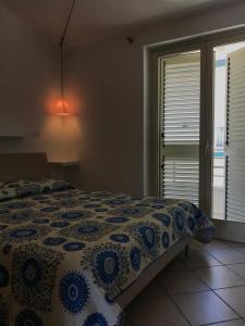 Ένα ή περισσότερα κρεβάτια σε δωμάτιο στο casa vacanze La Balena