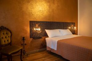 a hotel room with a bed and a lamp at Cairoly Rooms in Termoli