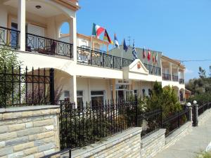 a large building with flags on the balconies at Amalia in Paleo Tsifliki