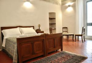 a bedroom with a bed and a table and a chair at Casa Turi in Alberobello