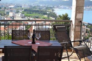 a table with wine glasses on top of a balcony at Apartments Milosevic in Bar