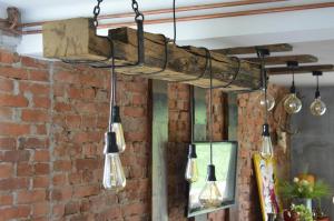 a group of lights hanging from a brick wall at Mystic River Design Hostel in Bajina Bašta