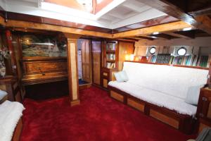 a train room with a white bench and a red carpet at Historic Wooden Ship 'MFV119' in East Cowes