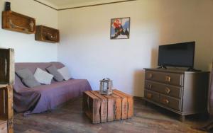 a bedroom with a bed and a dresser with a television at Appartement Style Campagne - Vue montagne - Exposé plein Sud - Belle terrasse - in Font-Romeu