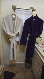 a robe and towels hanging on a wall at Riad Assalam in Marrakech