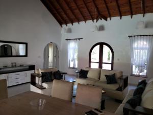 a living room with a couch and a table at Villas for Vacation 32-18-6 in Sosúa