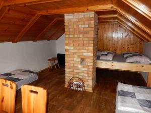 a room with two bunk beds and a brick wall at Chata v Moravském krasu in Sloup