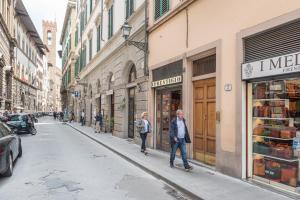 un hombre y una mujer caminando por una calle de la ciudad en Elegant and cozy flat heart of Florence, en Florencia