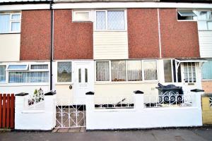 einem roten Backsteingebäude mit einer weißen Eingangstür in der Unterkunft The Chinatown Home - Private Garden, NETFLIX, BBQ & Bar in Birmingham