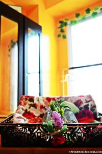 a tray with flowers on top of a couch at Wind Residences For Rent - Luiice in Tagaytay