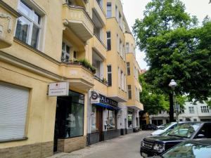 a building on a street with a car parked next to it at Ku'damm Taler's Central - Self Check In in Berlin