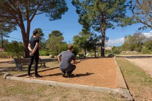 a man and a woman playing a game in a park at U Paesolu in Sainte-Lucie de Porto-Vecchio