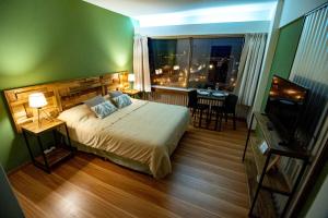 sypialnia z łóżkiem, biurkiem i oknem w obiekcie Patagonia Suite w mieście Bariloche
