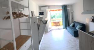 a room with a staircase and a living room at Studio rénové balcon ensoleillé et calme in La Londe-les-Maures