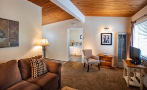 a living room with a couch and a bedroom at Redwood Suites in Ferndale