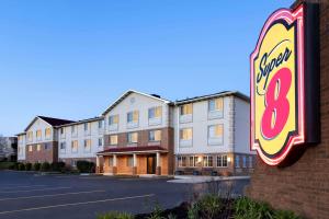 a motel sign in front of a building at Super 8 by Wyndham Akron S/Green/Uniontown OH in Uniontown