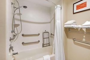 a bathroom with a shower and a tub at Comfort Inn Yulee - Fernandina Beach in Yulee
