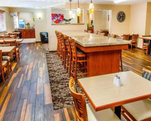a restaurant with wooden tables and chairs at Quality Inn Oakwood in Spokane