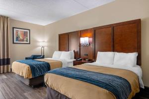 a hotel room with two beds and a desk at Comfort Inn Yulee - Fernandina Beach in Yulee