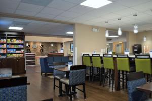 a room with tables, chairs, and tables in it at Comfort Suites Northside Hospital Gwinnett in Lawrenceville