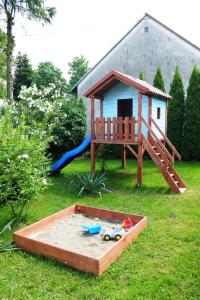 a sandbox with a play house and a slide at U Mariana in Mrukowa
