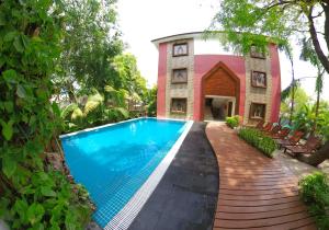 a house with a swimming pool in front of a house at Royal Bagan Hotel in Bagan