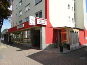 a red and white building on a city street at Hotel Sonne - Haus 1 in Idstein