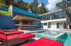a house with a swimming pool and red furniture at Cher​mantra​ Aonang​ Resort & Pool​ Suite in Ao Nang Beach