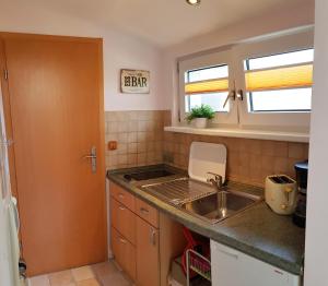 a small kitchen with a sink and a counter top at Ferienwohnung Graf Strandgut in Ostseebad Karlshagen