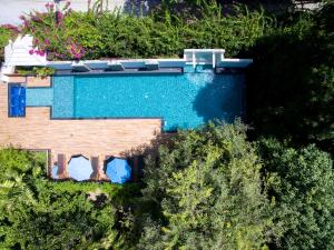an overhead view of a swimming pool next to a house at Sailom Hotel Hua Hin - SHA Extra Plus in Hua Hin