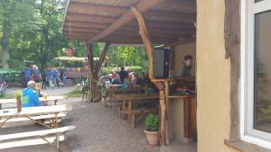 a group of people sitting at tables outside of a building at Haus Speck 5 in Kargow