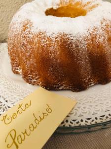 a donut on a plate next to a note at Hotel Adler in Menaggio