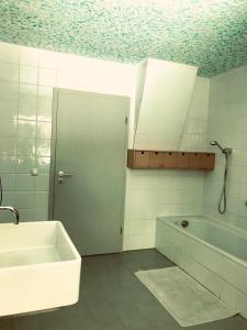 a bathroom with a sink and a bath tub at Talmühle Hirtscheid in Hirtscheid