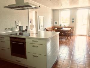 a kitchen with a counter and a dining room at Talmühle Hirtscheid in Hirtscheid