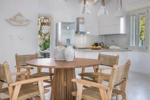 a kitchen with a wooden table and chairs at Olvio Living by the Sea in Sami