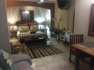 a living room with a couch and a table at Garden Apartments in Richards Bay