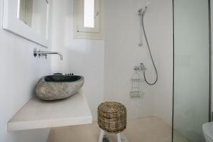 a bathroom with a sink and a glass shower at Olvio Living by the Sea in Sami +25 photos