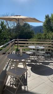 a table and chairs with an umbrella on a deck at B&B ALVINO in Bientina