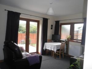 a living room with a table and a desk at Rockfoot B&B in Fintry