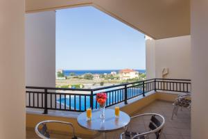a balcony with a table with a vase of flowers on it at Apartments Hotel & Studios, Xifoupolis in Monemvasia