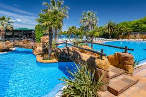 a pool at a resort with a water slide at Apartaments Solmar in Blanes