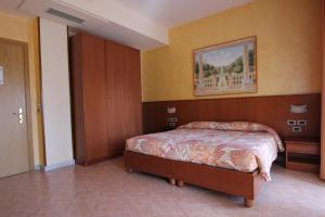 a bedroom with a bed and a painting on the wall at Hotel Oasi Dei Discepoli in Orvieto +40 photos