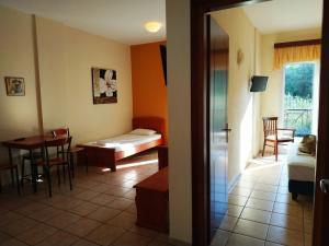 a room with a bed and a table and chairs at Amalia in Paleo Tsifliki