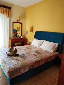 a bedroom with a bed with a purse on it at Amalia in Paleo Tsifliki