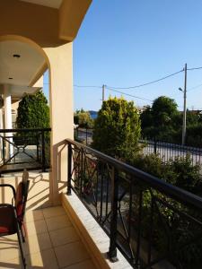 a balcony with a black railing and some bushes at Amalia in Paleo Tsifliki