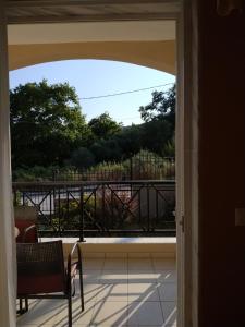 an open door to a balcony with a table and chair at Amalia in Paleo Tsifliki