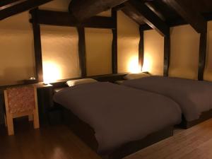 a bedroom with two beds and two lights in it at ShikiShiki Shinra in Kyoto